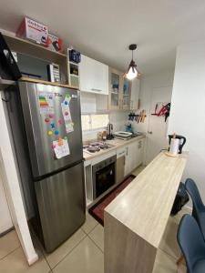 a kitchen with a stainless steel refrigerator and a counter at A pasos del mar Lugar ideal para descansar in El Tabo