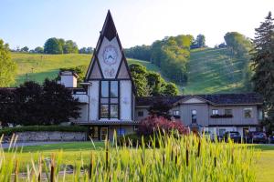 a house with a clock on the front of it at Boyne Mountain in Boyne Falls