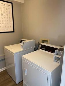 a room with two machines and a calendar on the wall at The Delores - 2 Bedroom Apt in Quilt Town, USA in Hamilton