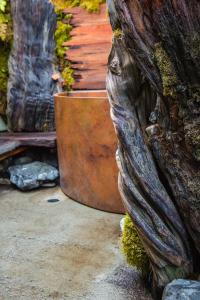 a large planter sitting next to a tree at The Front Porch Hidden Oasis in Arcata