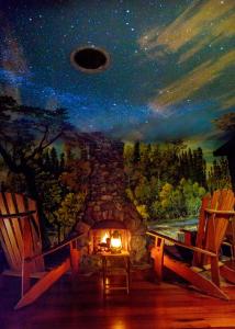 a painting of a stone fireplace with two chairs at The Front Porch Hidden Oasis in Arcata