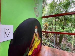 a painting of a woman painted on a wall at The Chorotega Arte y Sol Hotel in Montezuma