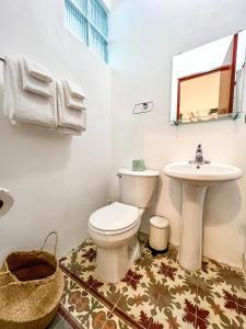 a bathroom with a toilet and a sink at Nando's Place in San Juan +11 photos