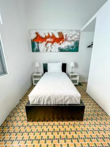 a bedroom with a bed and two night stands at Nando's Place in San Juan
