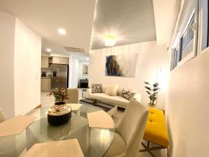 a living room with a couch and a table at ✰Upscale 3Bdr condo✰ Incredible amenities ✰Fast wifi in Tamarindo