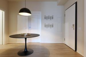 a black table in a room with a hallway at Luxury San Babila Apartment in Milan