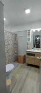 a bathroom with a sink and a toilet and a mirror at Kailani Tacoronte in Santa Cruz de Tenerife