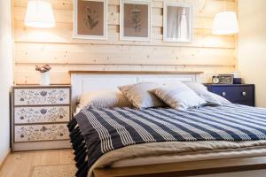a bedroom with a bed and a wooden wall at ŠTVRTÁ VODA - Jánska chata in Liptovský Ján