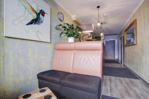 a room with a chair and a staircase with a bird on the wall at Hostel Westlight in Hamburg