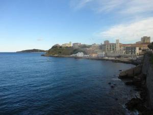 a large body of water with a city in the background at Casa dei MoMi in Piombino