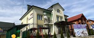 a house with a balcony on the side of it at Вілла ,,Астері'' in Skhidnitsa