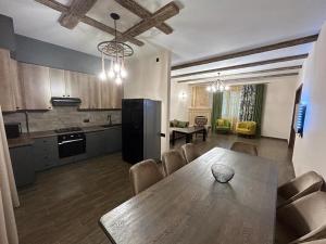 a kitchen and a dining room with a table and a kitchen at Capital Tsaghkadzor in Tsaghkadzor