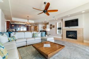 a living room with a white couch and a ceiling fan at Turquoise C702 in Orange Beach