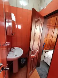 a small bathroom with a sink and a toilet at Chambre Hôtelière MB-301B - F1W in Douala