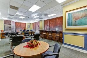 a waiting room with a table and chairs at Cozy Downtown One Bedroom Condo Jacksonville in Jacksonville