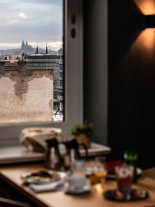 a table with a view of a city from a window at The Viaduct - Suites & More in Prague