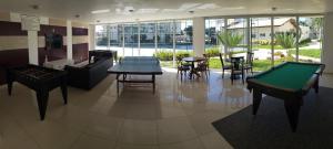 a room with a pool table and some tables and chairs at Nautilus Philadelphia - Penha-SC in Penha +39 photos