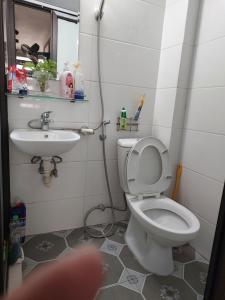 a bathroom with a toilet and a sink at HnH homestay in Hanoi