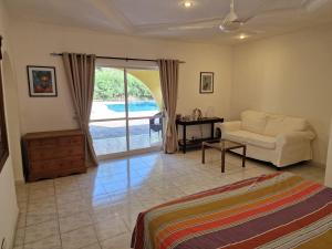 a living room with a bed and a couch at Tendinkoto Lodge in Sanyang