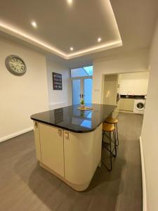 a kitchen with a large island in the middle of a room at A spacious & modern 3-bed home in Blackburn