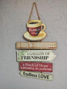 un cartel con una taza de café y libros en VINI studio with private parking, en Skopje