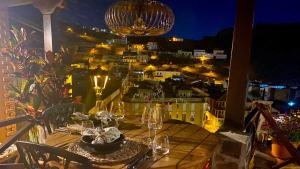 a table with wine glasses and a view of a city at Casa Moni con Vistas al Mar in Playa de Santiago