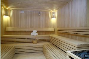 a sauna with wooden paneling and a white towel in it at Crowne Plaza Hotel Riyadh Minhal, an IHG Hotel in Riyadh