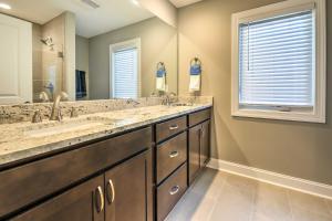 a bathroom with two sinks and a large mirror at Downtown Townhome Walk to Dine and Shop on Broad St in Southern Pines +17 photos