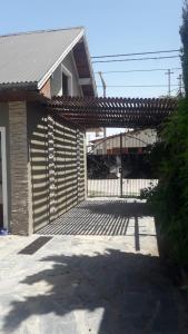 a building with a gate with a train behind it at Alquiler temporario en Necochea in Necochea