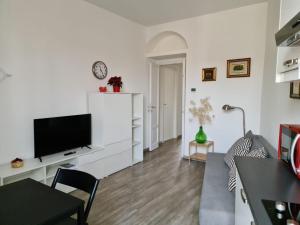 a living room with a flat screen tv on a white wall at WelcHome Marghera 18 in Milan