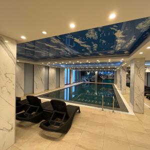a house with a swimming pool in the middle at President Kop - Silver Ice Apartment in Kopaonik
