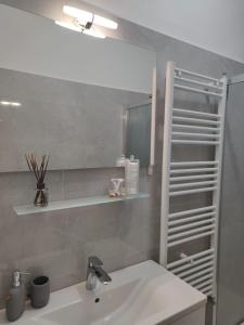 a bathroom with a sink and a mirror at Apartments Kinkela in Opatija +20 photos