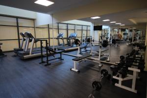a gym with tread machines and a man in the background at PARADISO 'B' 605 Private Apartment Nessebar in Nesebar