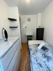Dormitorio pequeño con cama y barra en lovely 4 bedroom 2 bathroom home en Londres