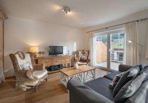 a living room with a couch and a tv at Ferienhaus Wirtheim in Brixen im Thale