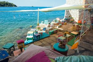 a group of tables and chairs next to the water at Apartment Mediterraneo in Rovinj