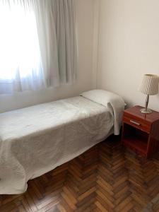 a small bedroom with a bed and a window at Barrancas de Belgrano in Buenos Aires