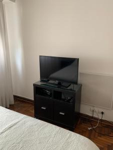 a flat screen tv on a dresser in a bedroom at Barrancas de Belgrano in Buenos Aires