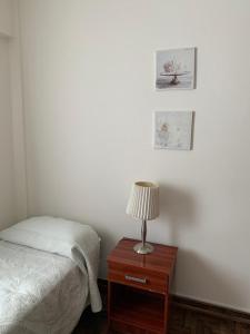 a bedroom with a bed and a table with a lamp at Barrancas de Belgrano in Buenos Aires