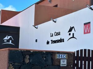 een bord aan de zijkant van een gebouw bij La casa de Tenesedra in Mocanal