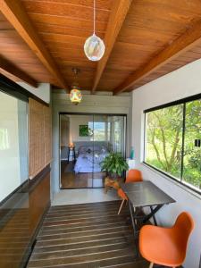 a room with a bed and a table and chairs at Guest room Casa SEA in Florianópolis