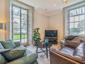 a living room with two couches and a tv at Arnside View in Arnside