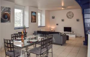 a dining room and living room with a table and chairs at 2 Bedroom Amazing Home In Brlidy in Brélidy