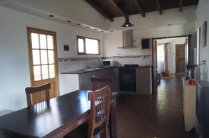 a kitchen with a wooden table and a dining room at Casagrande in Esquel