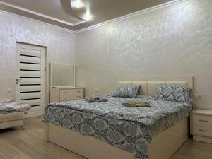 a bedroom with a bed and a dresser in it at OUR House in Vagharshapat