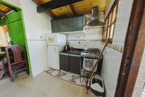 a small kitchen with a stove and a sink at Cabañas Riberas del Paraná in Puerto Iguazú