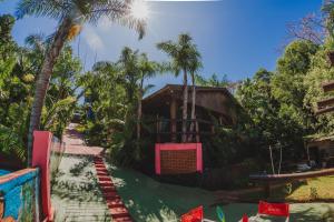 a resort with palm trees and a building at Cabañas Riberas del Paraná in Puerto Iguazú