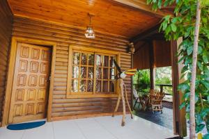 a wooden cabin with a door and a porch at Cabañas Riberas del Paraná in Puerto Iguazú