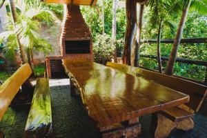 a wooden bench sitting in front of a brick fireplace at Cabañas Riberas del Paraná in Puerto Iguazú