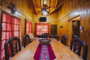 a dining room with a wooden table with a bowl on it at Cabañas Riberas del Paraná in Puerto Iguazú